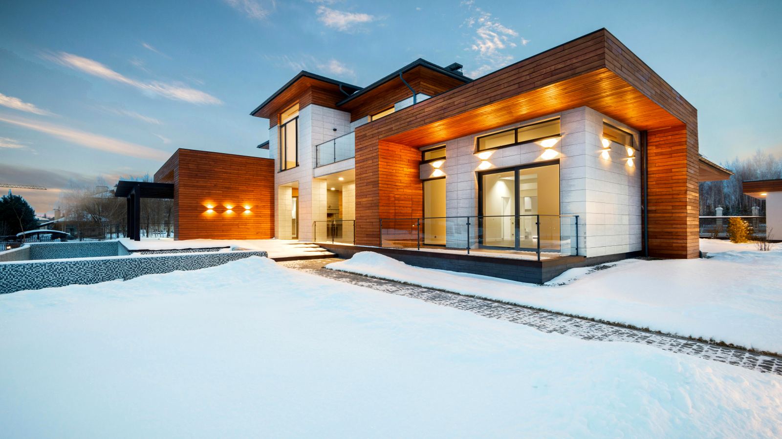 Contemporary home lit up in winter